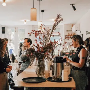 a group of people standing around a bar