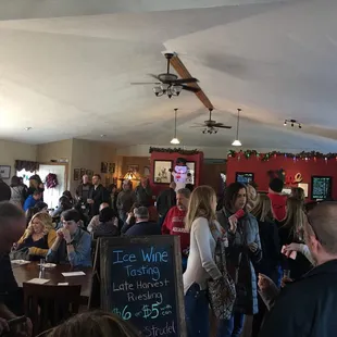 a crowd of people at a wine tasting