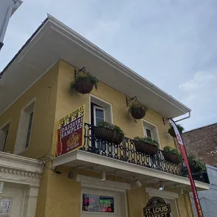 a yellow building with a balcony
