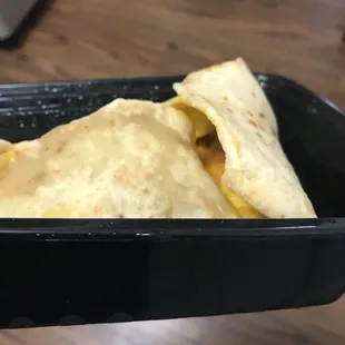tortilla in a black container
