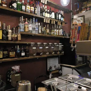 a bar with a lot of bottles on the wall