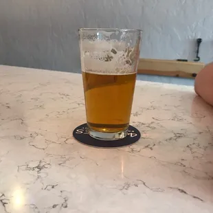 a glass of beer on a table