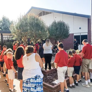 St. Peter Lutheran Lodi students pray during "See You At The Pole" 2019