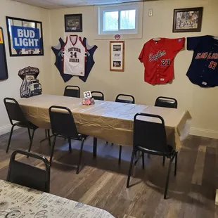 a dining room with baseball jerseys on the wall