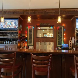 a bar with three televisions