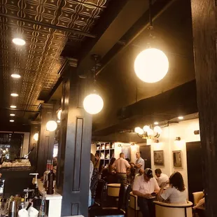 people sitting at tables in a restaurant