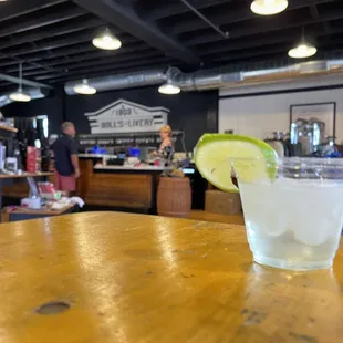 a drink in a glass with a lime wedge