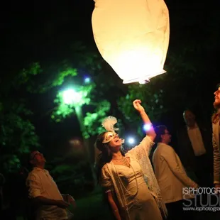 a woman holding a lantern in the air