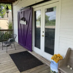 a porch with a purple door