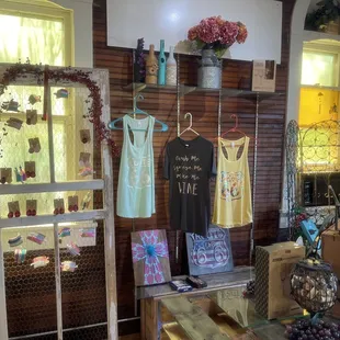 a display of wine bottles and t - shirts