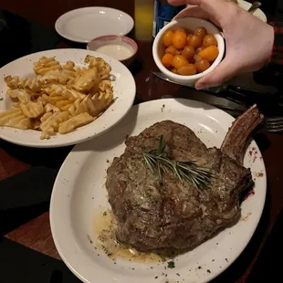 Cowboy ribeye with carrots and fries