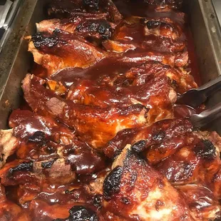 a pan of ribs with bbq sauce