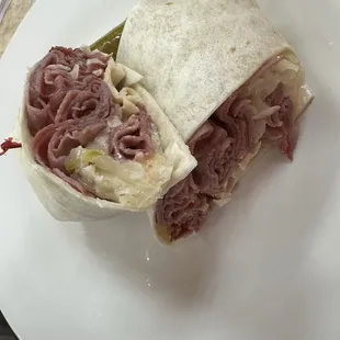 Rueben in a wrap.  Hot, kraut and 1000 island dressing as it should be. They need a different side or provide a better quality pickle.