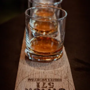 a row of glasses of whiskey