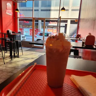 a red tray with a drink on it