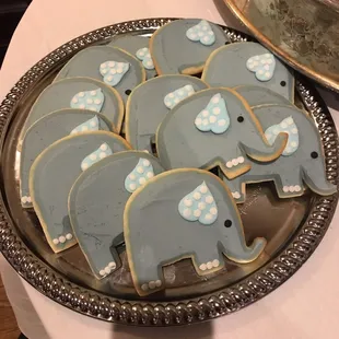 a platter of decorated cookies with blue elephants