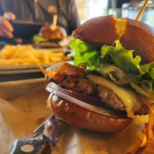 Stacked my own: Pretzel Bun, Beef Patty, Pepperjack Cheese, Lettuce, Tomato, Onion, and Applewood Smoked Bacon