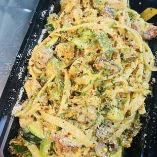 a plate of pasta with broccoli and parmesan cheese