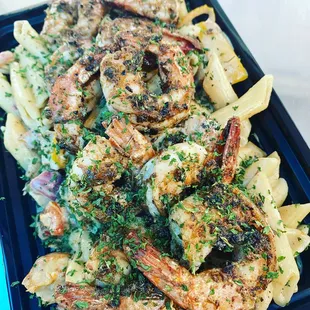 shrimp and vegetables on top of pasta