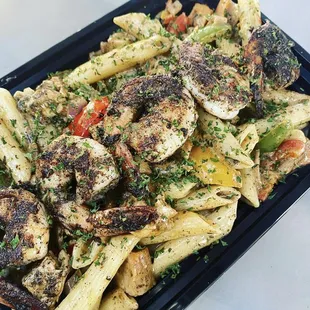 a plate of pasta with chicken and vegetables