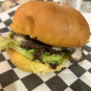a hamburger with lettuce and cheese