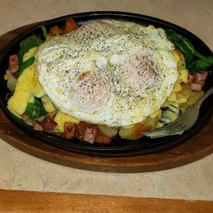 Daily special 4-22, ham, spinach, tomato, potato skillet, topped with hollandaise sauce and eggs of your choice, plus biscuit or toast.