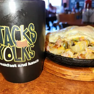 a plate of food and a coffee mug