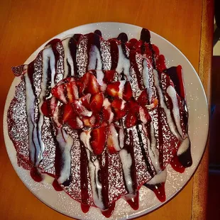a plate of pancakes and strawberries
