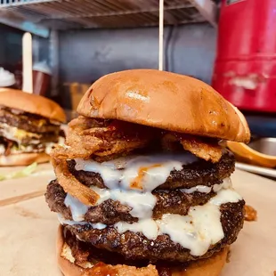 a stack of hamburgers on a table