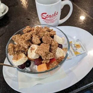 Granola yogurt fruit bowl with honey