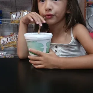 Olivia cooling off w. A soda at Stacy's.