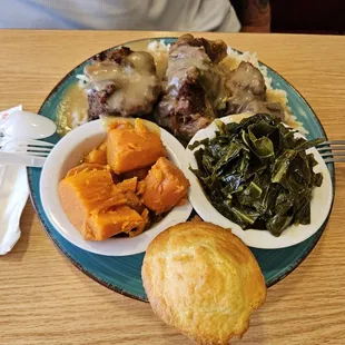 Ox tails with smothered rice. Yams and greens and muffin.