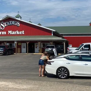 a white car parked in front of the store