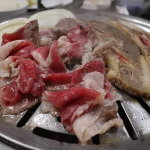 a close up of meat on a grill