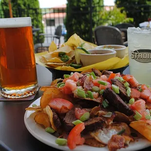 a plate of nachos and a glass of beer