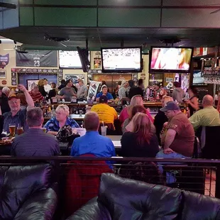a large group of people eating and drinking