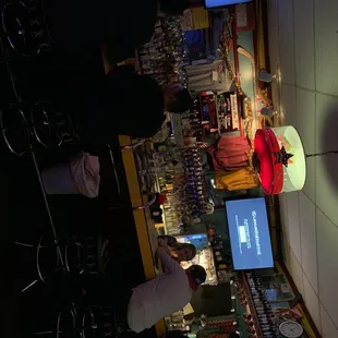 a bar with people standing at the bar