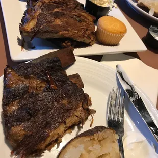 Ribs, baked potato, cole slaw and corn bread