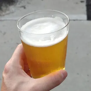 a person holding a glass of beer