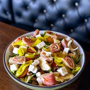 Antipasto Salad with romaine, feta, olives, tomato, artichoke heart, pepperocini, provolone, pepperoni, capicola, balsamic vinaigrette