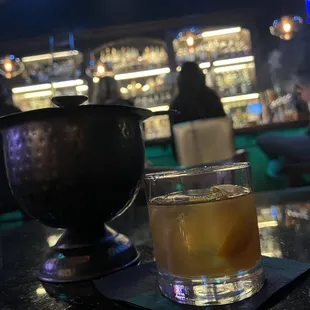 a drink in a glass and a pitcher