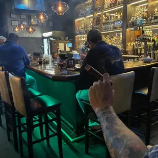 a man taking a picture of a bar