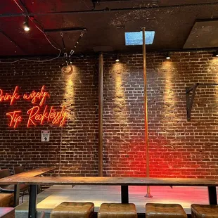a brick wall with a neon sign
