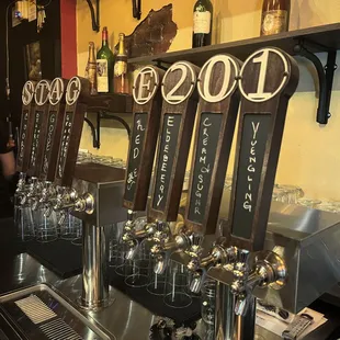 a row of beer taps on a bar