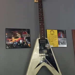 a guitar hanging on a wall