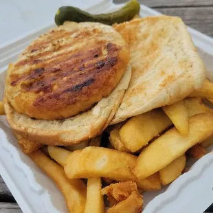 Deluxe turkey burger with fries and pickle! There's tomato and lettuce under the bun/pickle.