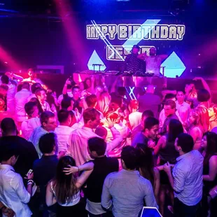 a crowd of people dancing at a nightclub