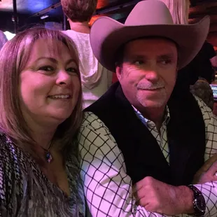 a man in a cowboy hat with a woman