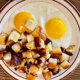fried eggs and potatoes on a plate