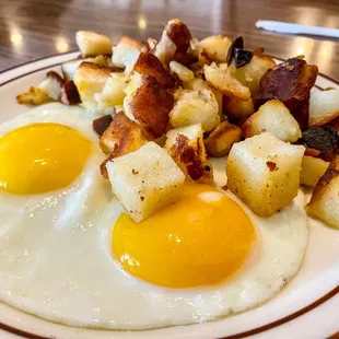 fried eggs and potatoes on a plate